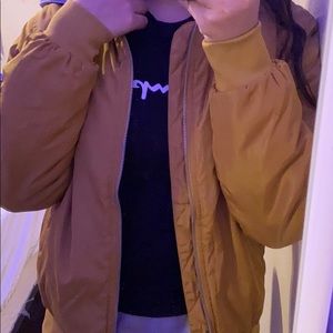 A light brown hooded bomber jacket